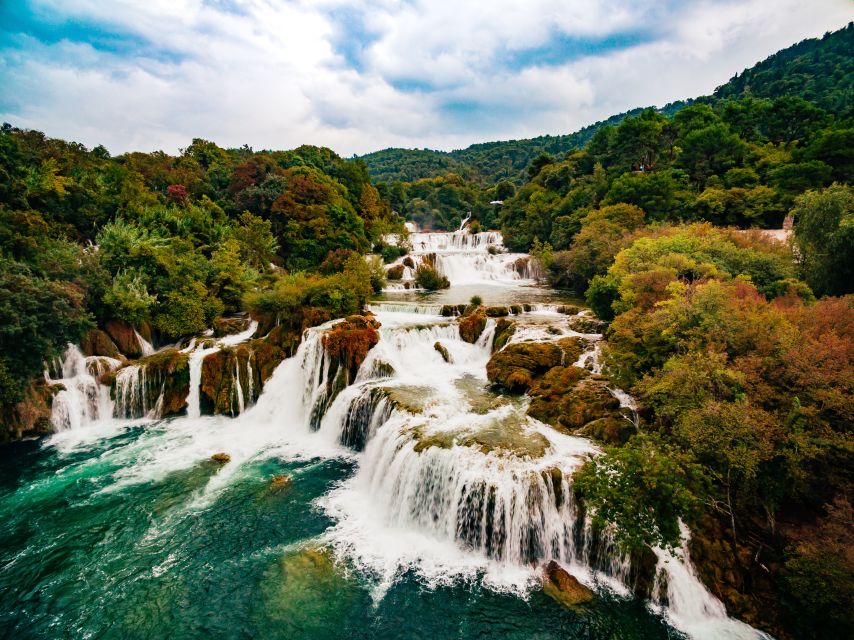 From Split & Trogir: Krka Waterfalls Day Tour with Boat Ride - Inside the park: trails, travertine cascades, and the little heritage stops