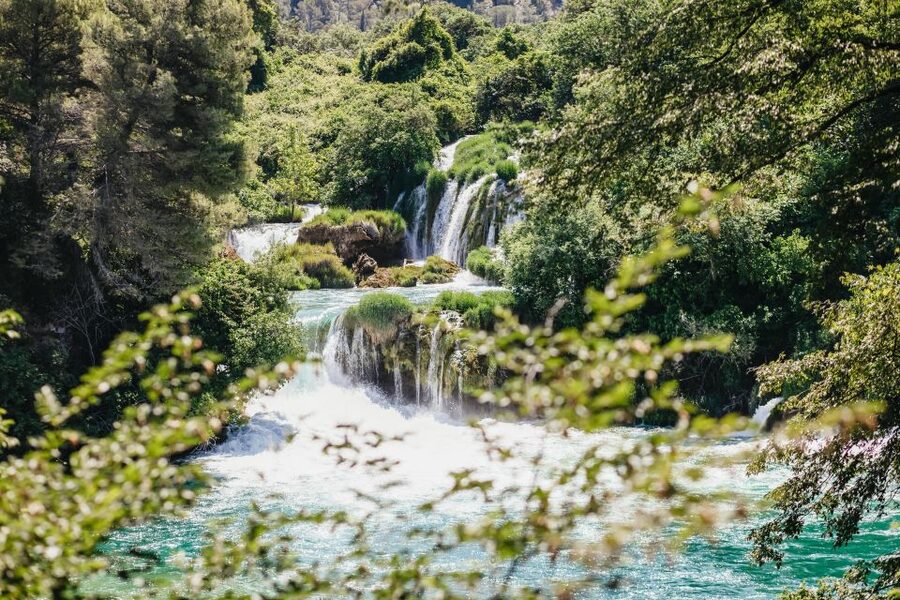 Split: Krka Waterfalls Trip with Boat Cruise and Swimming - Primošten stop: pebble beach swim time and a slower coastal pace